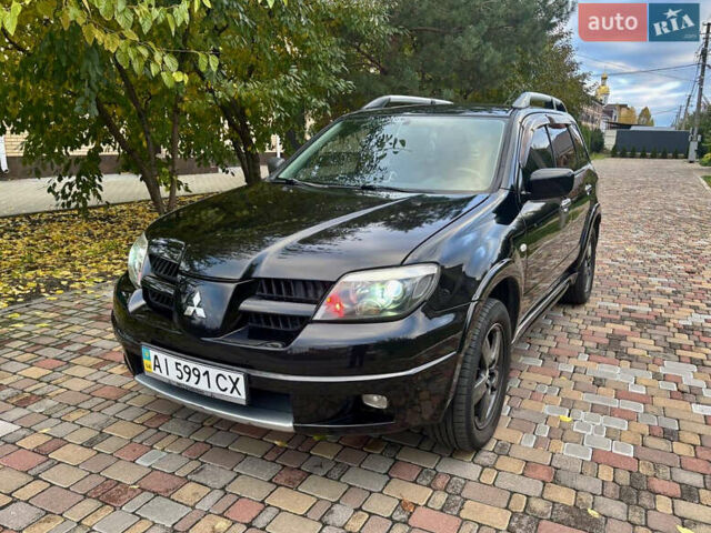 Чорний Міцубісі Аутлендер, об'ємом двигуна 2.38 л та пробігом 247 тис. км за 5499 $, фото 5 на Automoto.ua