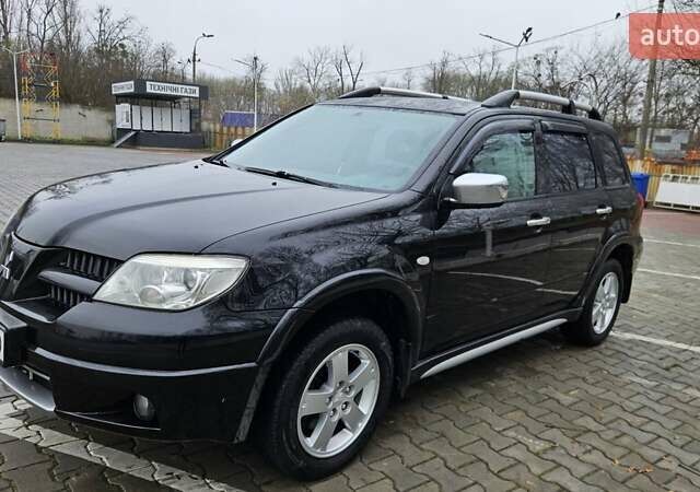 Черный Мицубиси Аутлендер, объемом двигателя 2.4 л и пробегом 167 тыс. км за 6150 $, фото 4 на Automoto.ua