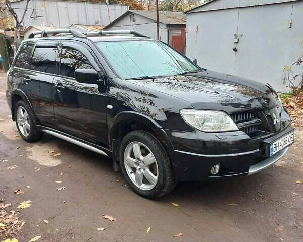 Черный Мицубиси Аутлендер, объемом двигателя 2.4 л и пробегом 256 тыс. км за 6900 $, фото 2 на Automoto.ua