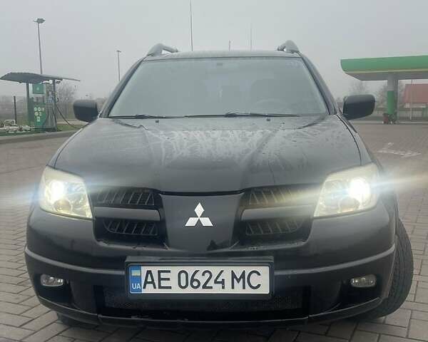 Черный Мицубиси Аутлендер, объемом двигателя 2.4 л и пробегом 277 тыс. км за 6700 $, фото 1 на Automoto.ua