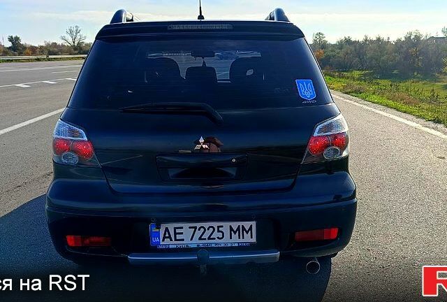 Черный Мицубиси Аутлендер, объемом двигателя 2.4 л и пробегом 265 тыс. км за 7500 $, фото 1 на Automoto.ua