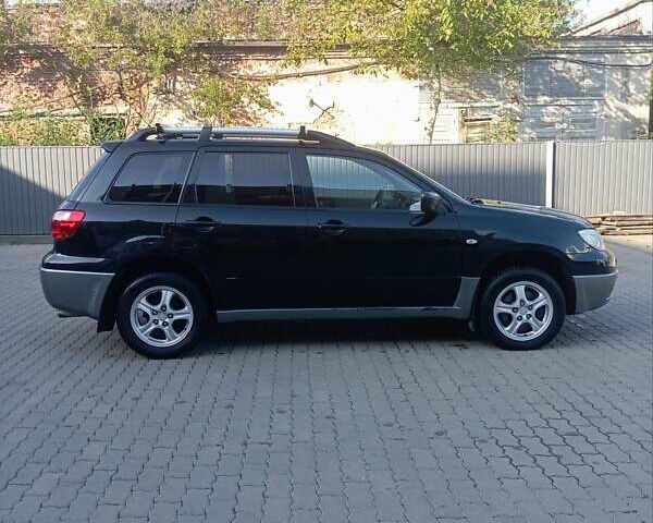 Черный Мицубиси Аутлендер, объемом двигателя 2 л и пробегом 297 тыс. км за 4550 $, фото 4 на Automoto.ua