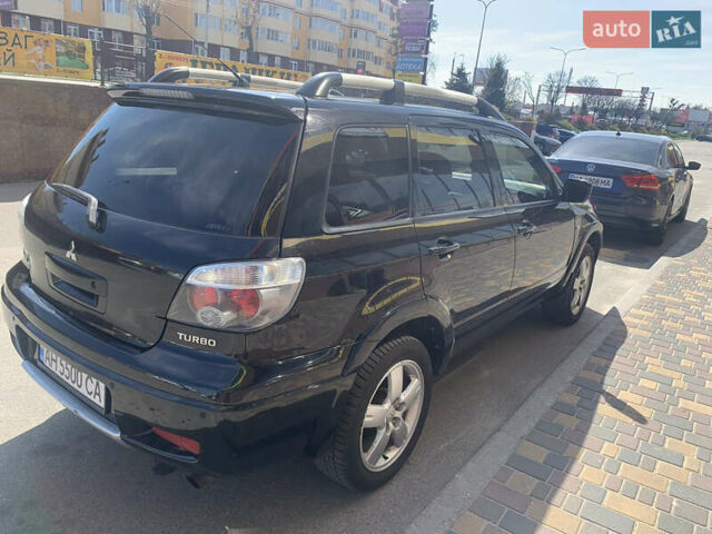 Черный Мицубиси Аутлендер, объемом двигателя 2 л и пробегом 212 тыс. км за 6000 $, фото 2 на Automoto.ua