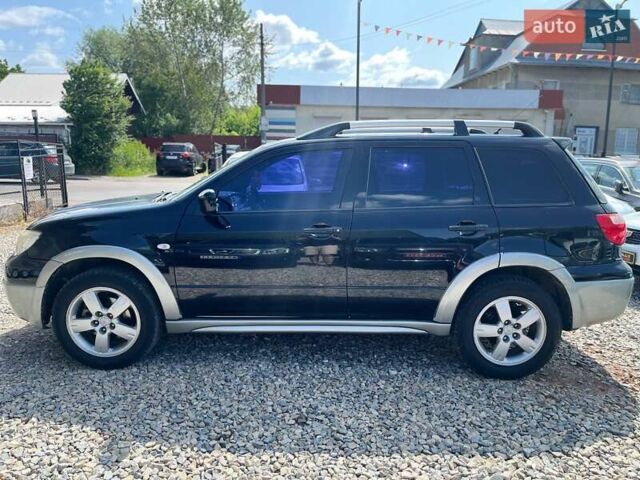 Черный Мицубиси Аутлендер, объемом двигателя 2.4 л и пробегом 270 тыс. км за 5999 $, фото 2 на Automoto.ua