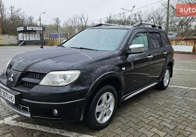 Черный Мицубиси Аутлендер, объемом двигателя 2.4 л и пробегом 167 тыс. км за 6150 $, фото 3 на Automoto.ua