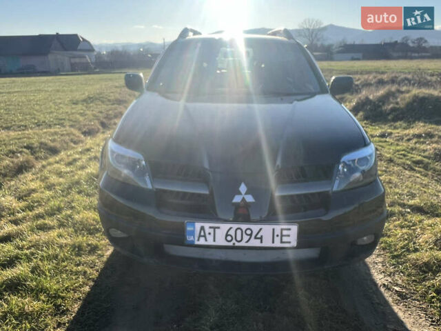 Черный Мицубиси Аутлендер, объемом двигателя 2.38 л и пробегом 230 тыс. км за 5350 $, фото 1 на Automoto.ua