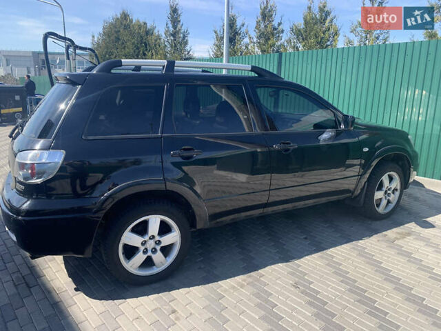 Черный Мицубиси Аутлендер, объемом двигателя 2 л и пробегом 212 тыс. км за 6000 $, фото 28 на Automoto.ua