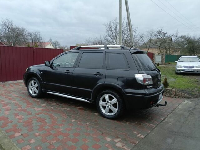 Черный Мицубиси Аутлендер, объемом двигателя 2 л и пробегом 200 тыс. км за 5100 $, фото 4 на Automoto.ua