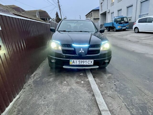 Черный Мицубиси Аутлендер, объемом двигателя 2.4 л и пробегом 234 тыс. км за 5499 $, фото 2 на Automoto.ua