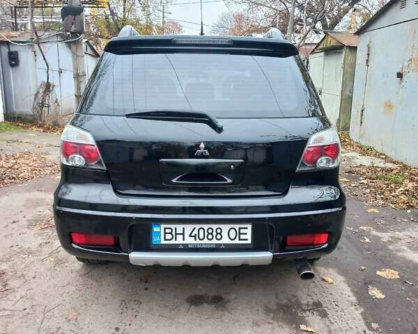 Черный Мицубиси Аутлендер, объемом двигателя 2.4 л и пробегом 256 тыс. км за 6900 $, фото 4 на Automoto.ua