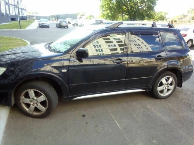 Черный Мицубиси Аутлендер, объемом двигателя 2.4 л и пробегом 240 тыс. км за 5700 $, фото 1 на Automoto.ua