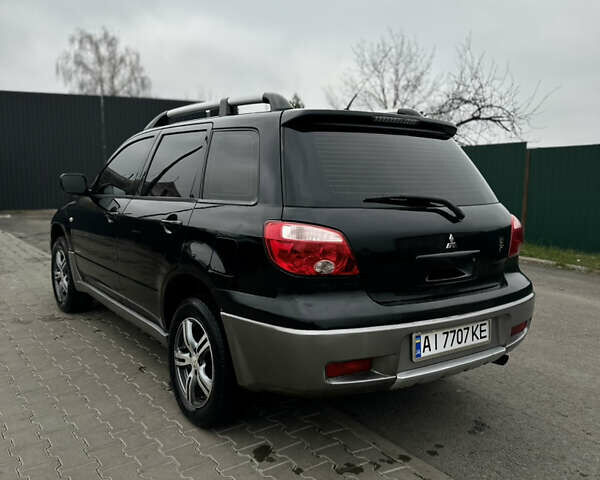 Чорний Міцубісі Аутлендер, об'ємом двигуна 2 л та пробігом 297 тис. км за 6200 $, фото 2 на Automoto.ua