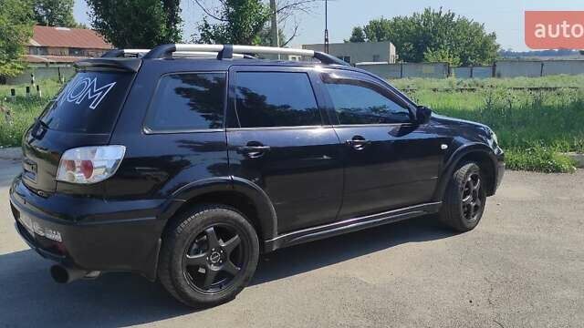 Черный Мицубиси Аутлендер, объемом двигателя 2 л и пробегом 216 тыс. км за 5600 $, фото 4 на Automoto.ua