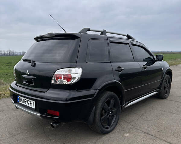 Черный Мицубиси Аутлендер, объемом двигателя 2 л и пробегом 230 тыс. км за 6300 $, фото 1 на Automoto.ua