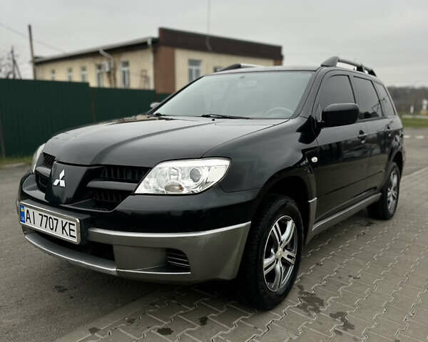 Чорний Міцубісі Аутлендер, об'ємом двигуна 2 л та пробігом 297 тис. км за 6200 $, фото 1 на Automoto.ua