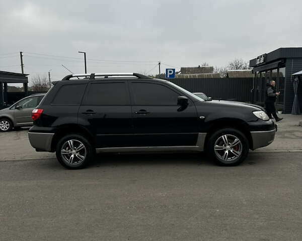 Чорний Міцубісі Аутлендер, об'ємом двигуна 2 л та пробігом 297 тис. км за 6200 $, фото 10 на Automoto.ua