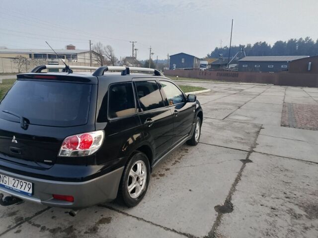 Черный Мицубиси Аутлендер, объемом двигателя 2 л и пробегом 169 тыс. км за 3500 $, фото 1 на Automoto.ua