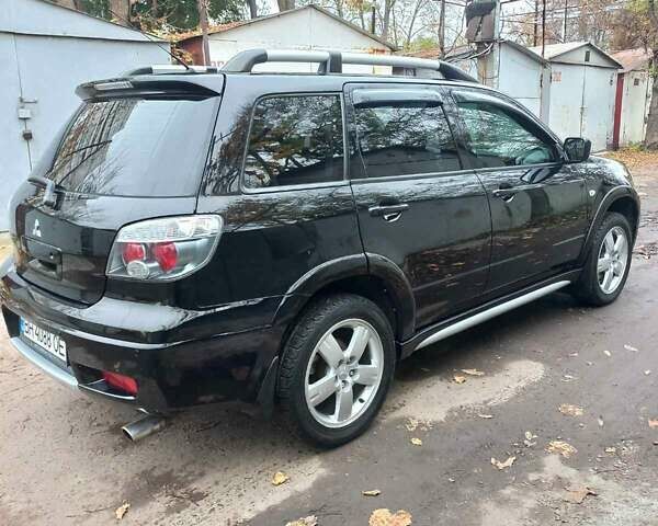 Черный Мицубиси Аутлендер, объемом двигателя 2.4 л и пробегом 256 тыс. км за 6900 $, фото 5 на Automoto.ua