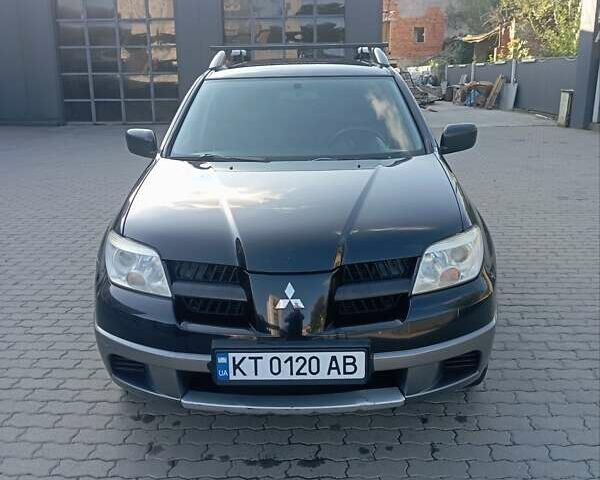 Черный Мицубиси Аутлендер, объемом двигателя 2 л и пробегом 297 тыс. км за 4550 $, фото 1 на Automoto.ua