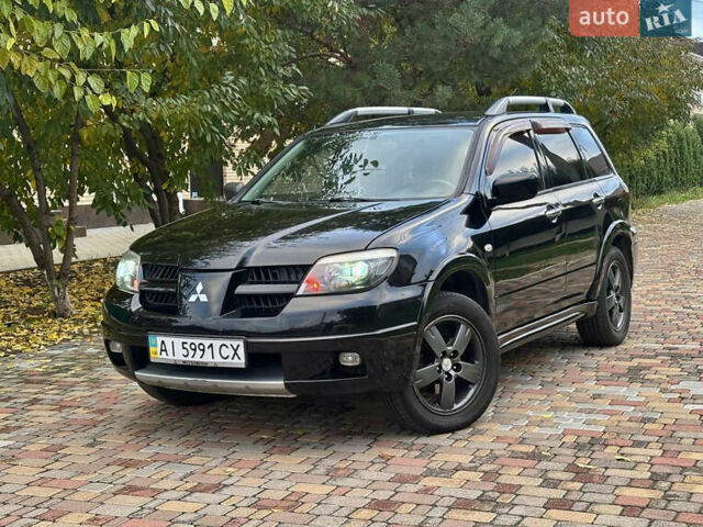 Чорний Міцубісі Аутлендер, об'ємом двигуна 2.38 л та пробігом 247 тис. км за 5499 $, фото 1 на Automoto.ua