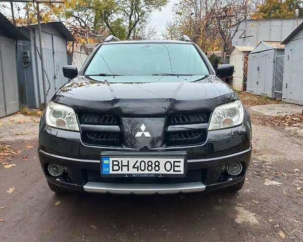 Черный Мицубиси Аутлендер, объемом двигателя 2.4 л и пробегом 256 тыс. км за 6900 $, фото 1 на Automoto.ua