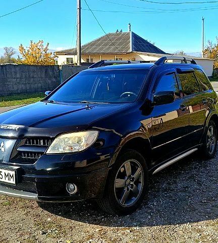 Черный Мицубиси Аутлендер, объемом двигателя 2.4 л и пробегом 265 тыс. км за 7500 $, фото 5 на Automoto.ua