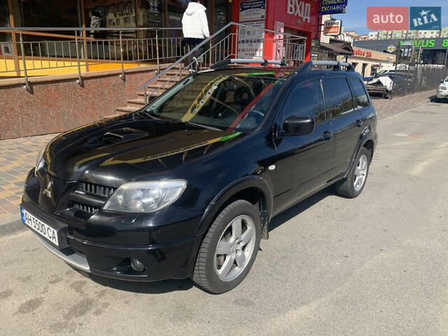 Черный Мицубиси Аутлендер, объемом двигателя 2 л и пробегом 212 тыс. км за 6000 $, фото 1 на Automoto.ua