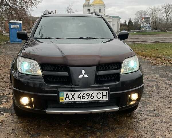 Чорний Міцубісі Аутлендер, об'ємом двигуна 2.4 л та пробігом 213 тис. км за 6850 $, фото 2 на Automoto.ua