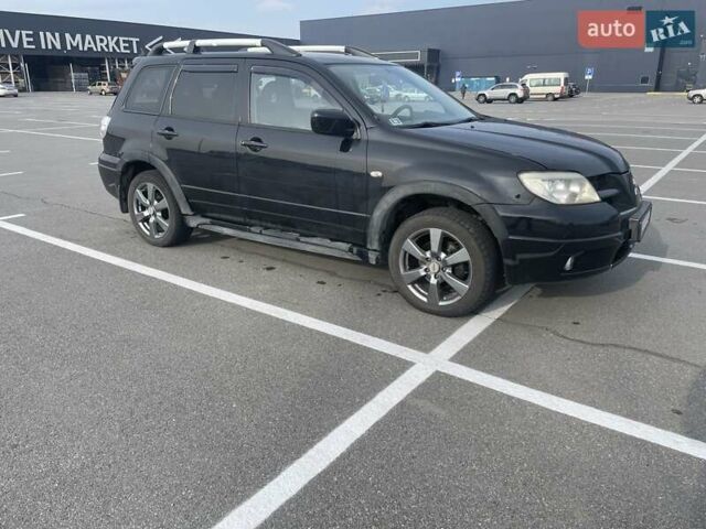 Черный Мицубиси Аутлендер, объемом двигателя 2.38 л и пробегом 180 тыс. км за 6900 $, фото 1 на Automoto.ua