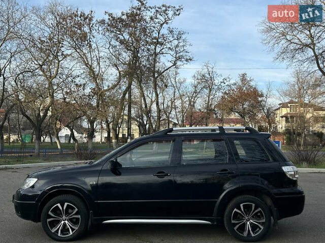 Черный Мицубиси Аутлендер, объемом двигателя 2.4 л и пробегом 320 тыс. км за 5999 $, фото 6 на Automoto.ua