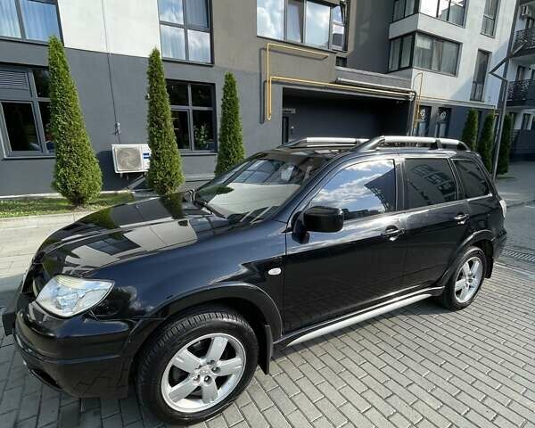 Черный Мицубиси Аутлендер, объемом двигателя 2.38 л и пробегом 310 тыс. км за 7500 $, фото 1 на Automoto.ua