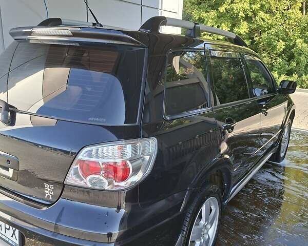 Черный Мицубиси Аутлендер, объемом двигателя 2.4 л и пробегом 270 тыс. км за 6900 $, фото 5 на Automoto.ua