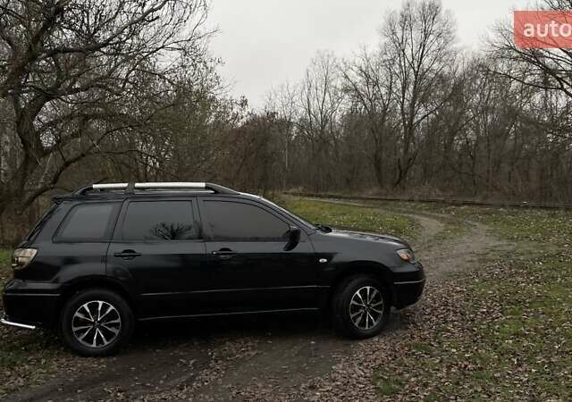 Черный Мицубиси Аутлендер, объемом двигателя 2.38 л и пробегом 215 тыс. км за 5800 $, фото 1 на Automoto.ua