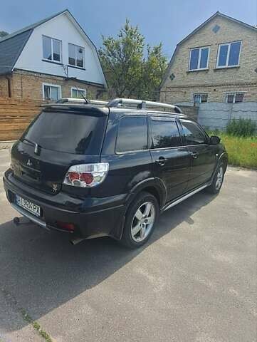Черный Мицубиси Аутлендер, объемом двигателя 2.4 л и пробегом 270 тыс. км за 6900 $, фото 3 на Automoto.ua