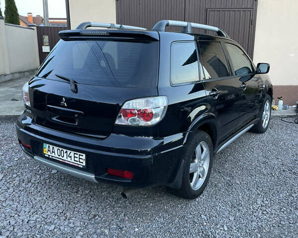 Черный Мицубиси Аутлендер, объемом двигателя 2.38 л и пробегом 118 тыс. км за 6850 $, фото 3 на Automoto.ua