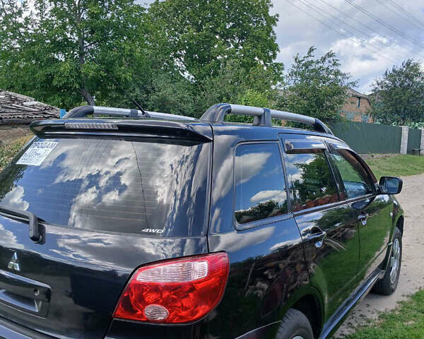 Чорний Міцубісі Аутлендер, об'ємом двигуна 2 л та пробігом 161 тис. км за 7499 $, фото 4 на Automoto.ua