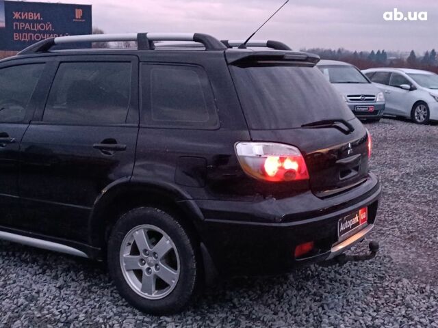 Черный Мицубиси Аутлендер, объемом двигателя 2 л и пробегом 271 тыс. км за 6940 $, фото 5 на Automoto.ua