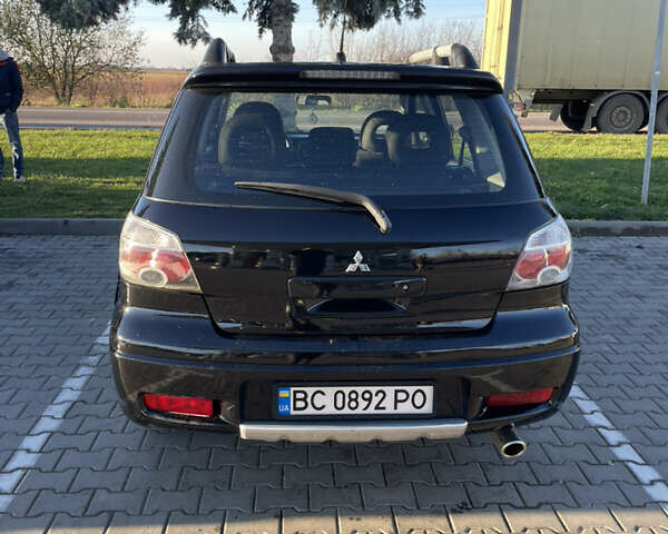 Чорний Міцубісі Аутлендер, об'ємом двигуна 2 л та пробігом 218 тис. км за 6300 $, фото 4 на Automoto.ua