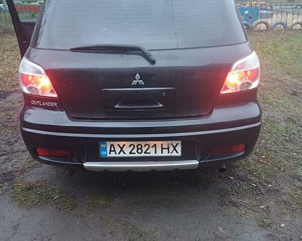 Черный Мицубиси Аутлендер, объемом двигателя 2.4 л и пробегом 270 тыс. км за 6700 $, фото 3 на Automoto.ua