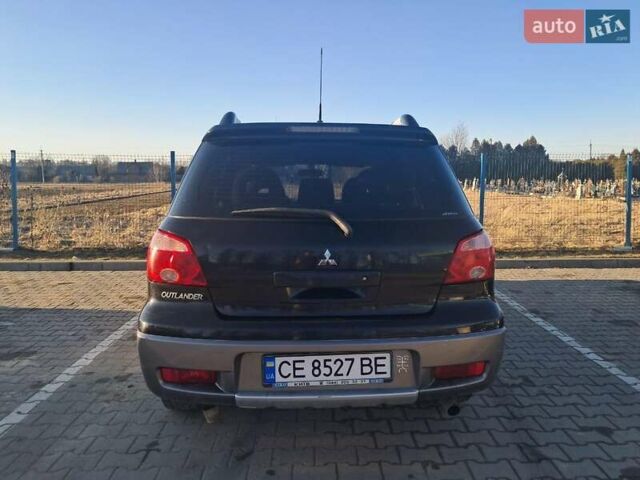 Черный Мицубиси Аутлендер, объемом двигателя 2 л и пробегом 190 тыс. км за 8000 $, фото 2 на Automoto.ua