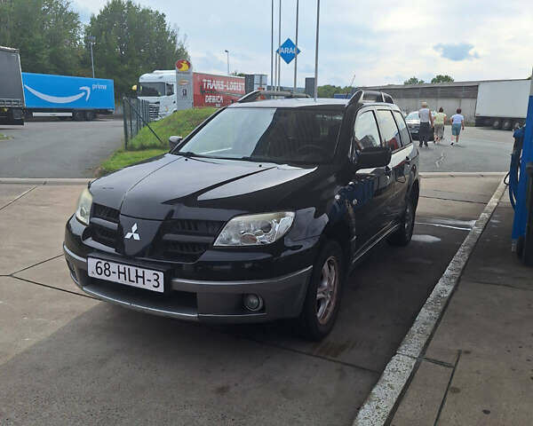 Чорний Міцубісі Аутлендер, об'ємом двигуна 2 л та пробігом 254 тис. км за 7499 $, фото 23 на Automoto.ua