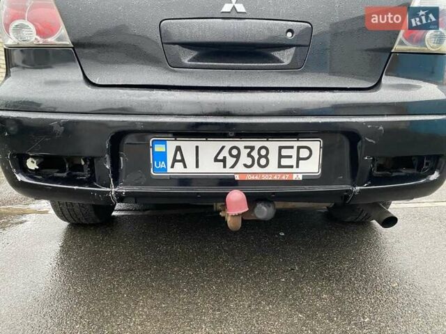 Черный Мицубиси Аутлендер, объемом двигателя 2 л и пробегом 306 тыс. км за 6500 $, фото 19 на Automoto.ua