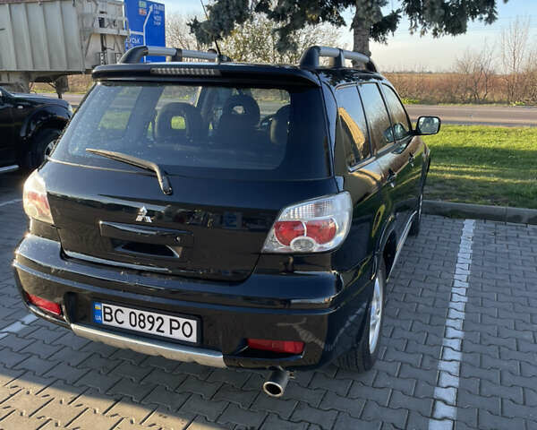Чорний Міцубісі Аутлендер, об'ємом двигуна 2 л та пробігом 218 тис. км за 6300 $, фото 2 на Automoto.ua