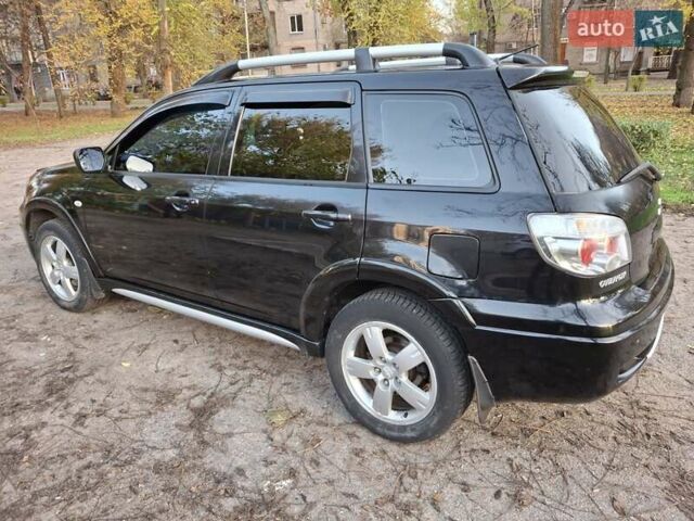 Чорний Міцубісі Аутлендер, об'ємом двигуна 2.38 л та пробігом 245 тис. км за 6800 $, фото 6 на Automoto.ua