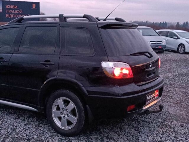 Черный Мицубиси Аутлендер, объемом двигателя 2 л и пробегом 271 тыс. км за 6940 $, фото 5 на Automoto.ua