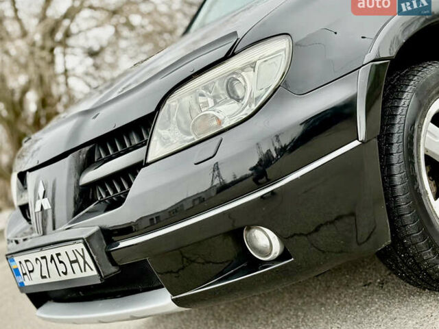 Черный Мицубиси Аутлендер, объемом двигателя 2.4 л и пробегом 245 тыс. км за 6500 $, фото 2 на Automoto.ua