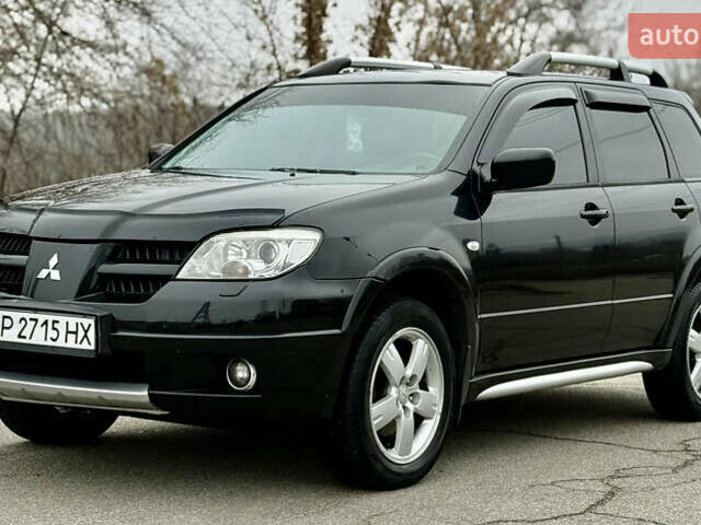 Черный Мицубиси Аутлендер, объемом двигателя 2.4 л и пробегом 245 тыс. км за 6500 $, фото 1 на Automoto.ua