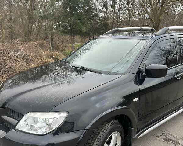 Чорний Міцубісі Аутлендер, об'ємом двигуна 2 л та пробігом 118 тис. км за 8100 $, фото 17 на Automoto.ua