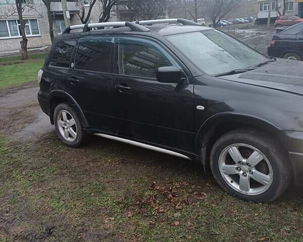 Черный Мицубиси Аутлендер, объемом двигателя 2.4 л и пробегом 270 тыс. км за 6700 $, фото 1 на Automoto.ua