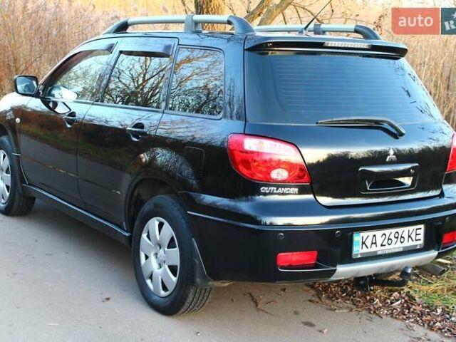 Черный Мицубиси Аутлендер, объемом двигателя 2 л и пробегом 189 тыс. км за 7200 $, фото 1 на Automoto.ua